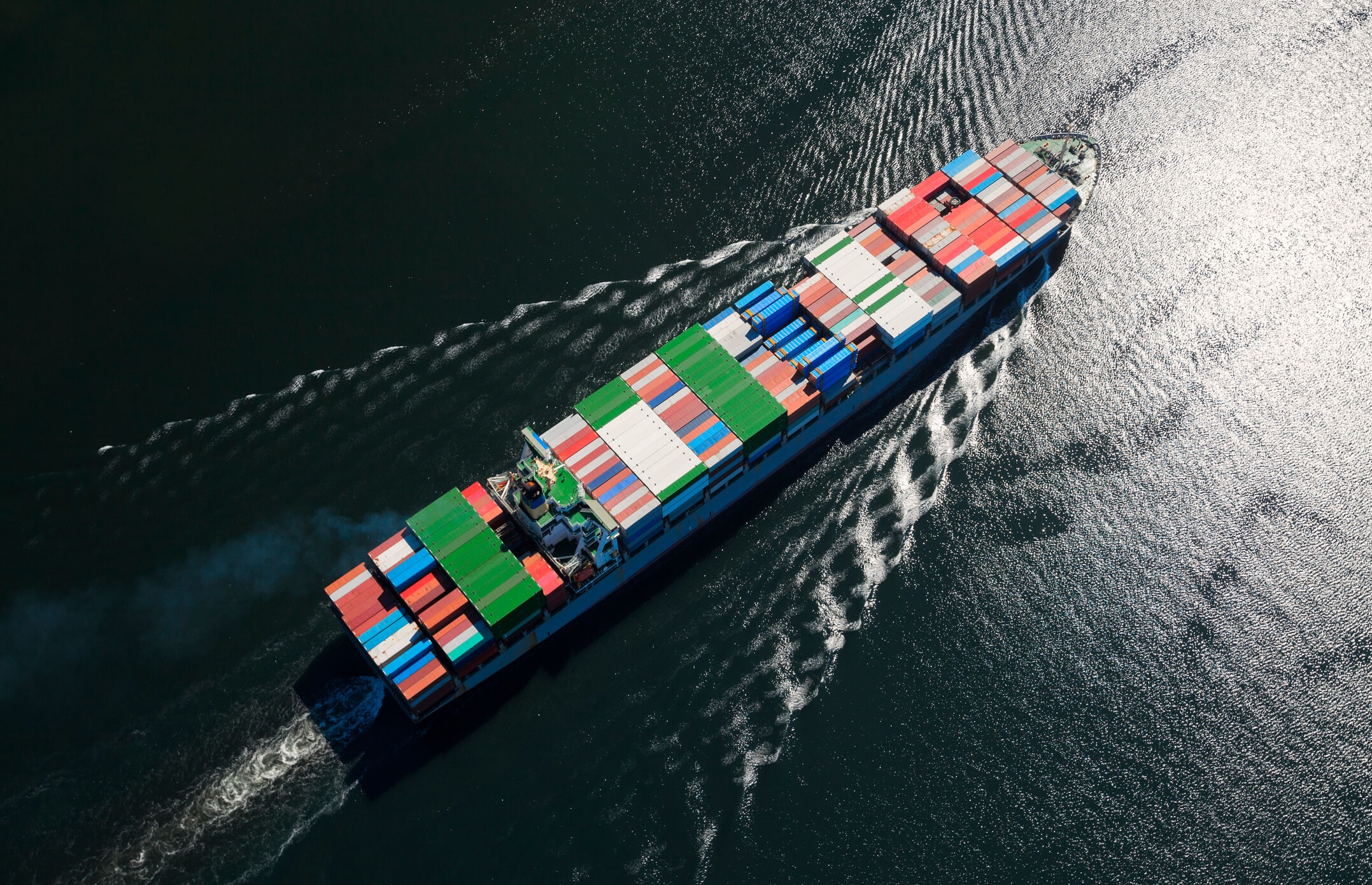 Ocean freighter in the water carrying multiple containers