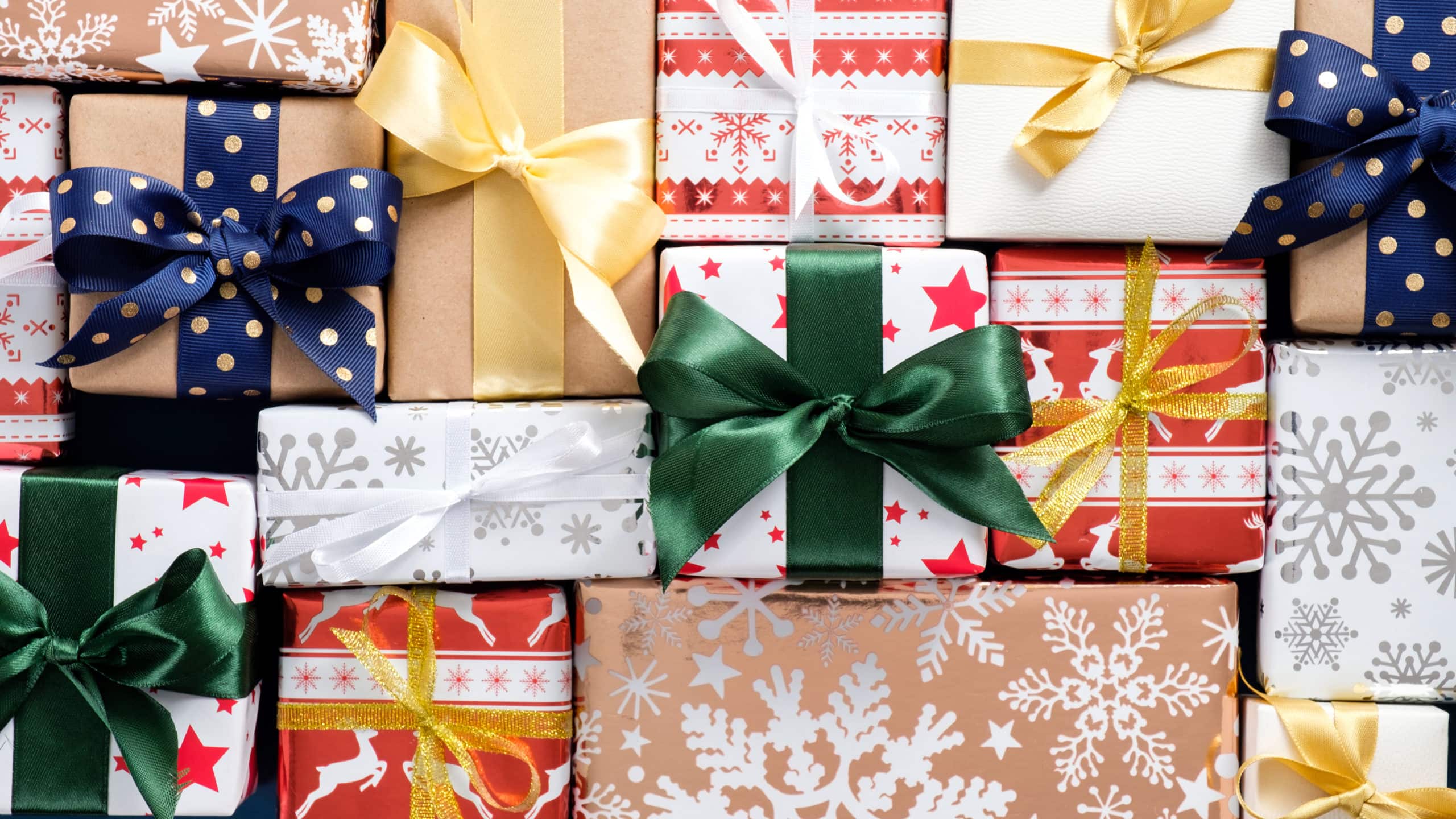 Christmas gift boxes collection top view. Flat lay Presents wrapped festive paper with colorful ribbon bows.